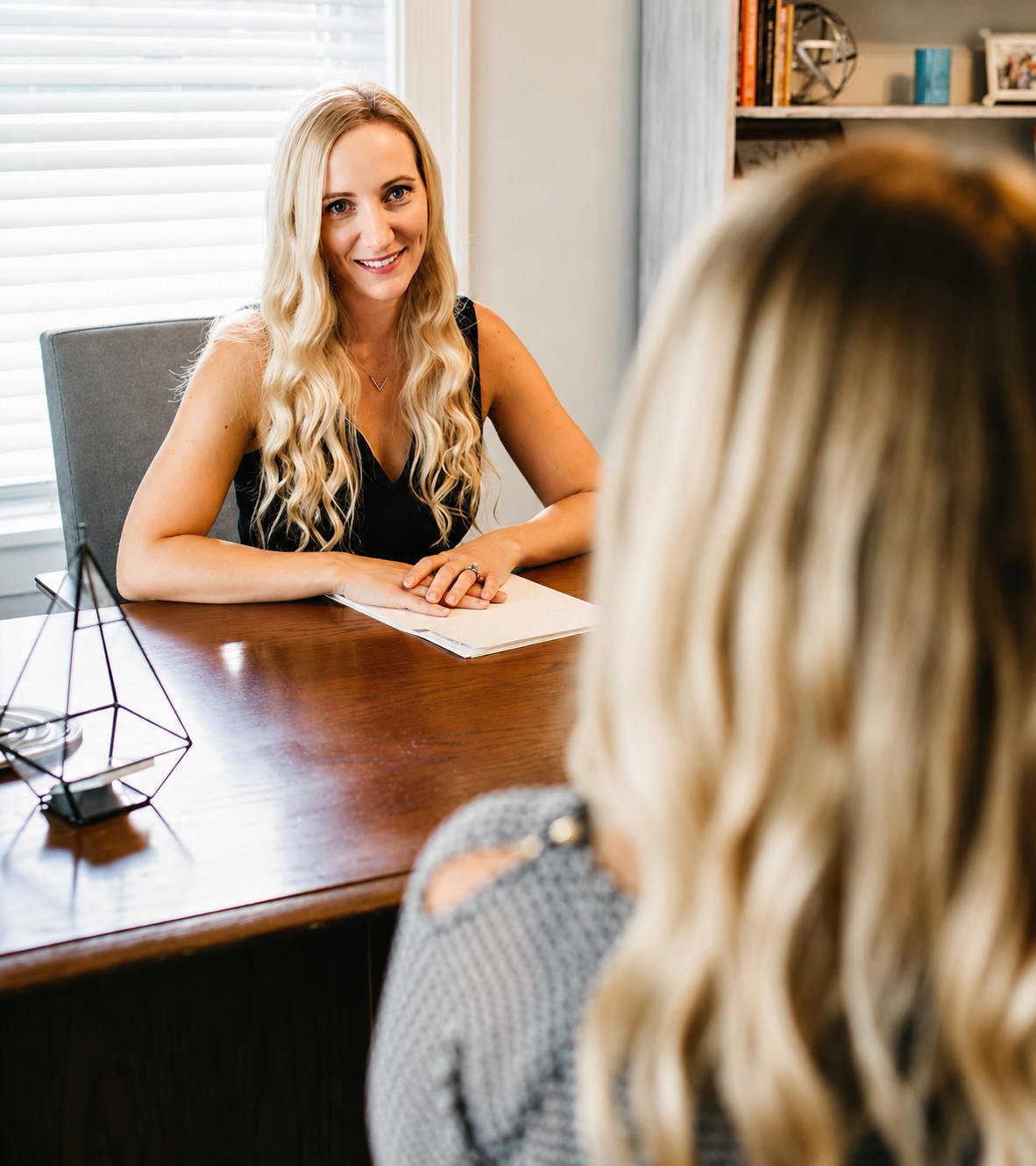 Dr. Jen meeting with a patient at her desk